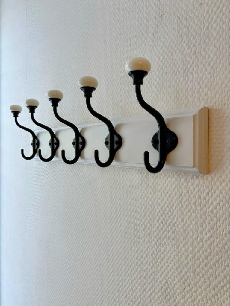 Wall-mounted coat rack installed in hallway